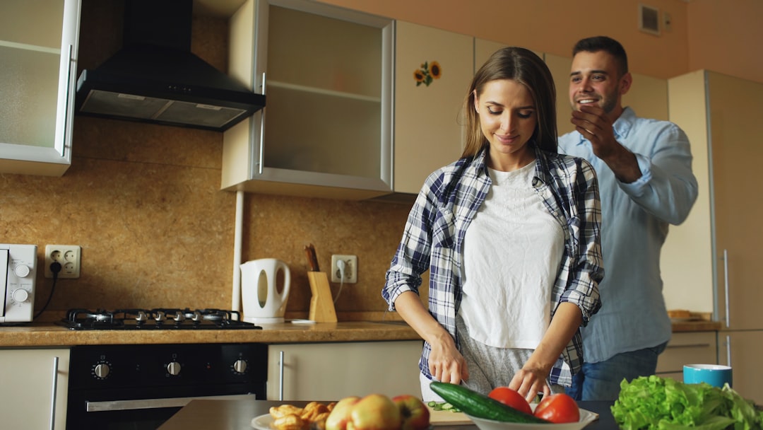 Couple preparing food together in a modern kitchen.