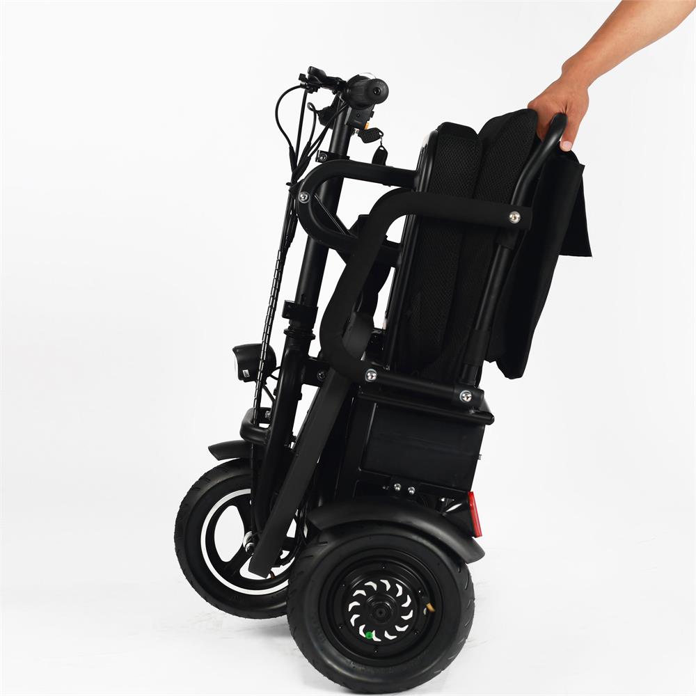 The front wheel of a black MotoTec folding mobility electric trike. The wheel is a large, 10-inch air-filled tire.